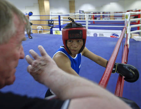 FILE PHOTO: India's boxer MC Mary Kom listens to her coach during a training session at Balewadi Stadium in Pune, about 190 km (118 miles) from Mumbai, March 12, 2012. REUTERS/Danish Siddiqui