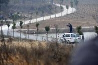 Policemen aim their rifles at a cow, which escaped from a truck, in Liangdun village of Nangang township, Anhui province December 15, 2013. The 700 kilogram (1,543 lb) cow attacked several farmers before being shot dead by the policemen, local media reported. Picture taken December 15, 2013. REUTERS/China Daily (CHINA - Tags: ANIMALS SOCIETY) CHINA OUT. NO COMMERCIAL OR EDITORIAL SALES IN CHINA