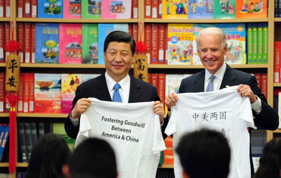 In this photo taken on February 17, 2012 when Joe Biden was vice president, he and his Chinese counterpart Xi Jinping display shirts with a message given to them by students at the International Studies Learning School in Southgate, outside Los Angeles. The two leaders met again Monday amid the G-20 summit in Indonesia.