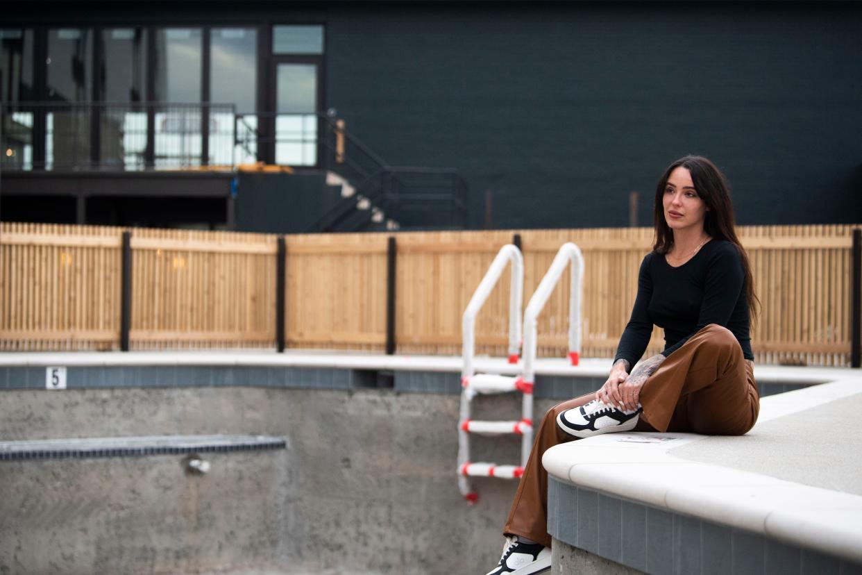 Alexis Soler, entrepreneur and bartender, sits by the pool side that is still under construction at Drift Hotel in Nashville , Tenn., Wednesday, Dec. 20, 2023.