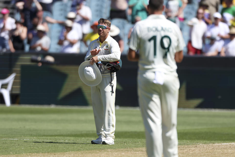 Australia's David Warner pauses during play for a tribute for former Australian cricket star Shane Warne who passed away earlier in the year, during the second cricket test between South Africa and Australia at the Melbourne Cricket Ground, Australia, Monday, Dec. 26, 2022. (AP Photo/Asanka Brendon Ratnayake)
