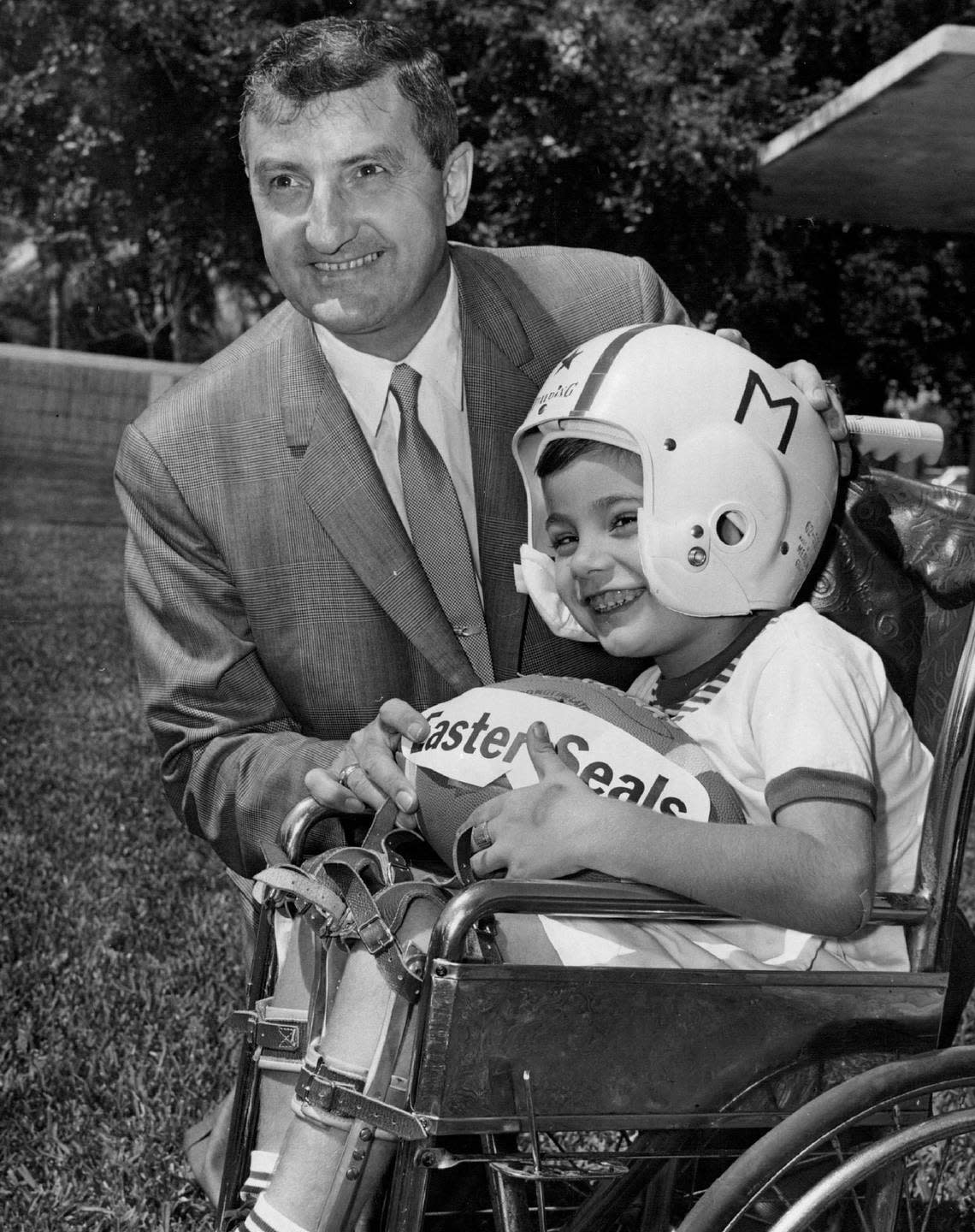 Four-year-old Cory Proudfoot, Miami-Dade’s Easter Seal poster child, gets encouragement from Miami Dolphins owner Joe Robbie in 1966, the team’s inaugural year.