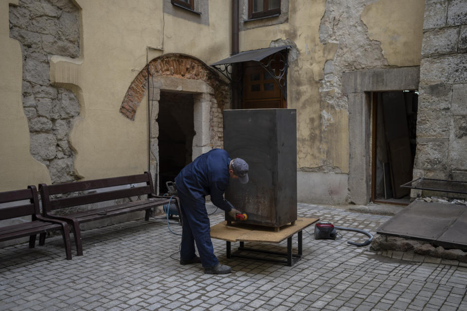 A worker of the Museum of the History of Religion builds a box to protect artifacts in the event of an attack in the western Ukrainian city of Lviv, western Ukraine, Friday, March 4, 2022. (AP Photo/Bernat Armangue)