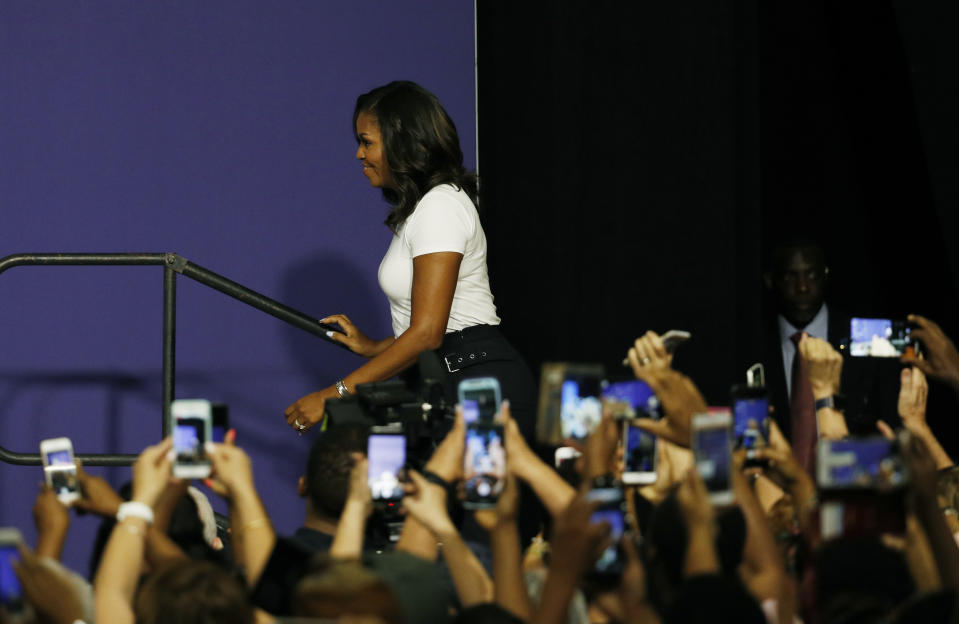 Former first lady Michelle Obama takes the stage at a rally to encourage voter registration, Sunday, Sept. 23, 2018, in Las Vegas. (AP Photo/John Locher)
