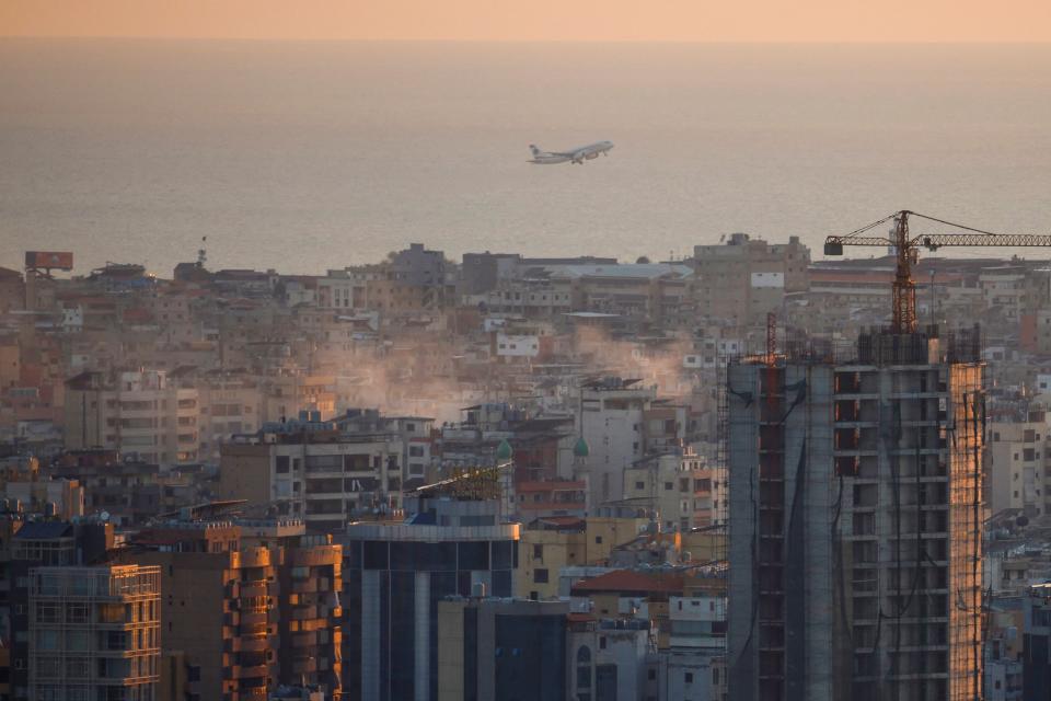 A commercial plane takes off from Beirut’s International Airport as smoke billows across the capital city following Israeli airstrikes (REUTERS)