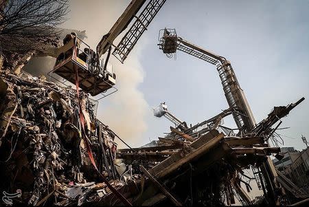 Rescue workers operate at the site of a collapsed high-rise building in Tehran, Iran January 19, 2017. Tasnim News Agency/Handout via REUTERS