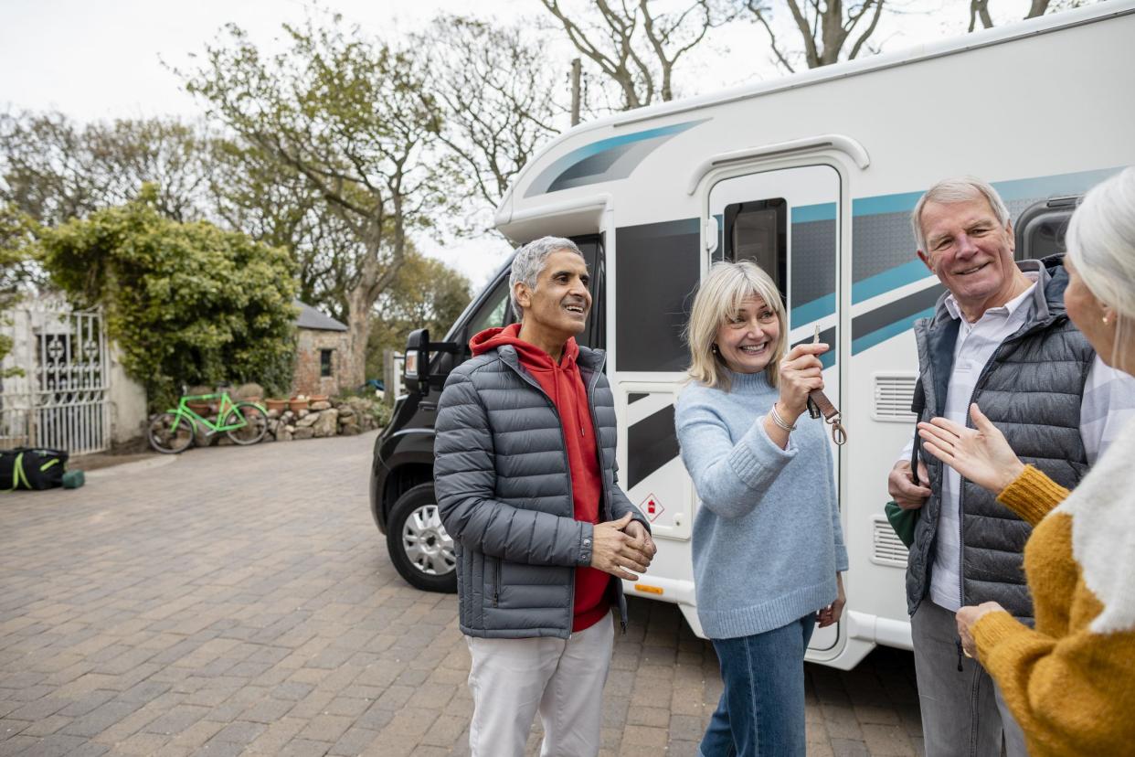 Two senior couples on a staycation together in Northumberland, England. They are travelling via a motorhome and are by the coast. They are meeting ip ready to start their journey.