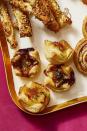 <p>Create cute cups by pressing puff pastry into muffin tins and dolloping jam (apricot, raspberry and fig are tasty!) and cubes of gooey Brie on top.</p><p>Get the <a href="https://www.goodhousekeeping.com/food-recipes/a30286112/brie-phyllo-cups-recipe/" rel="nofollow noopener" target="_blank" data-ylk="slk:Jammy Brie Cups recipe" class="link "><strong>Jammy Brie Cups recipe</strong></a>.</p>