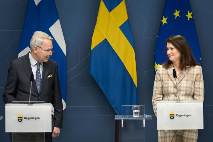Finland's Minister for Foreign Affairs Pekka Haavisto, left and his Swedish counterpart Ann Linde take part in a joint press conference with Sweden's Defence Minister Peter Hultqvist, and his Finnish counterpart Antti Kaikkonen, in Stockholm, Sweden, Wednesday, Feb. 2, 2022, after talks on European security. (Anders Wiklund, TT News Agency via AP)