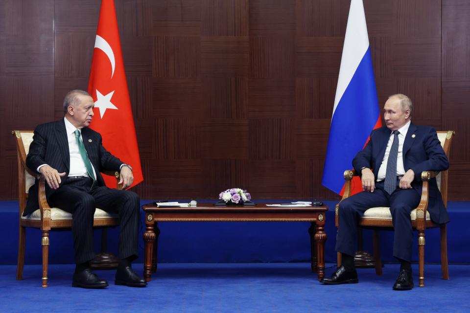 Russia's President Vladimir Putin, right, and Turkey's President Recep Tayyip Erdogan talk to each other during their meeting on sidelines of the Conference on Interaction and Confidence Building Measures in Asia (CICA) summit, in Astana, Kazakhstan, Thursday, Oct. 13, 2022. (Vyacheslav Prokofyev, Sputnik, Kremlin Pool Photo via AP)