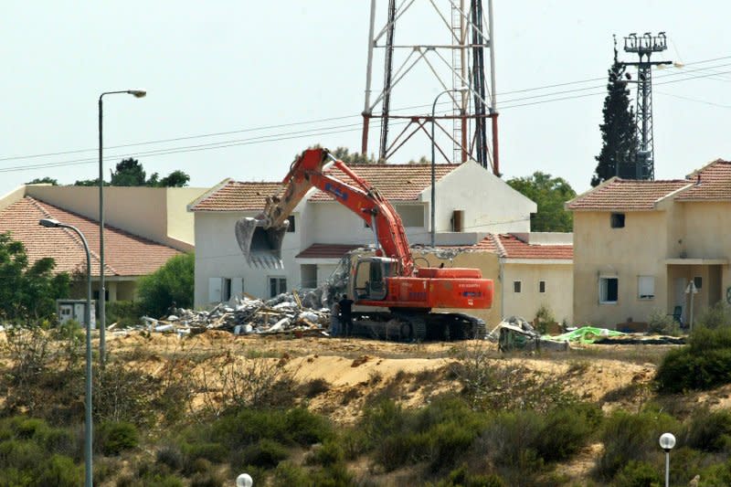 Israeli heavy equipment destroys a house in the Jewish settlement of Morag, southern Gaza Strip, August 22, 2005. Israeli troops marched unopposed into the Gaza Strip's last Jewish settlement of Netzarim on Monday to complete the evacuation of the territory after nearly four decades of occupation. File Photo by Ismael Mohamad/UPI