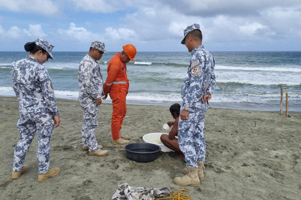 In this handout photo provided by the Philippine Coast Guard, Philippine Coast Guard personnel check on a fisherman while conducting patrol along shore lines in Ilocos Norte province, northern Philippines, as they prepare for the possible effects of Typhoon Mawar on Monday, May 29, 2023. Philippine officials began evacuating thousands of villagers, shut down schools and offices and imposed a no-sail ban Monday as Typhoon Mawar approached the country's northern provinces a week after battering the U.S. territory of Guam. (Philippine Coast Guard via AP)
