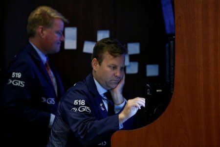 Traders work on the floor of the New York Stock Exchange (NYSE) in New York, U.S., June 19, 2018. REUTERS/Brendan McDermid