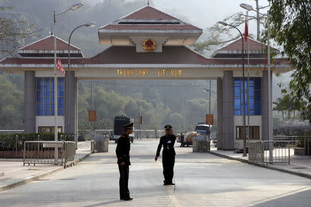 A Chinese border guard officer stops the photographer from taking pictures at the Tian Bao border gate opposite of Vietnam's Thanh Thuy border gate, in China's Southwest province of Yunnan in this February 13, 2009 file photo. REUTERS/Kham/Files