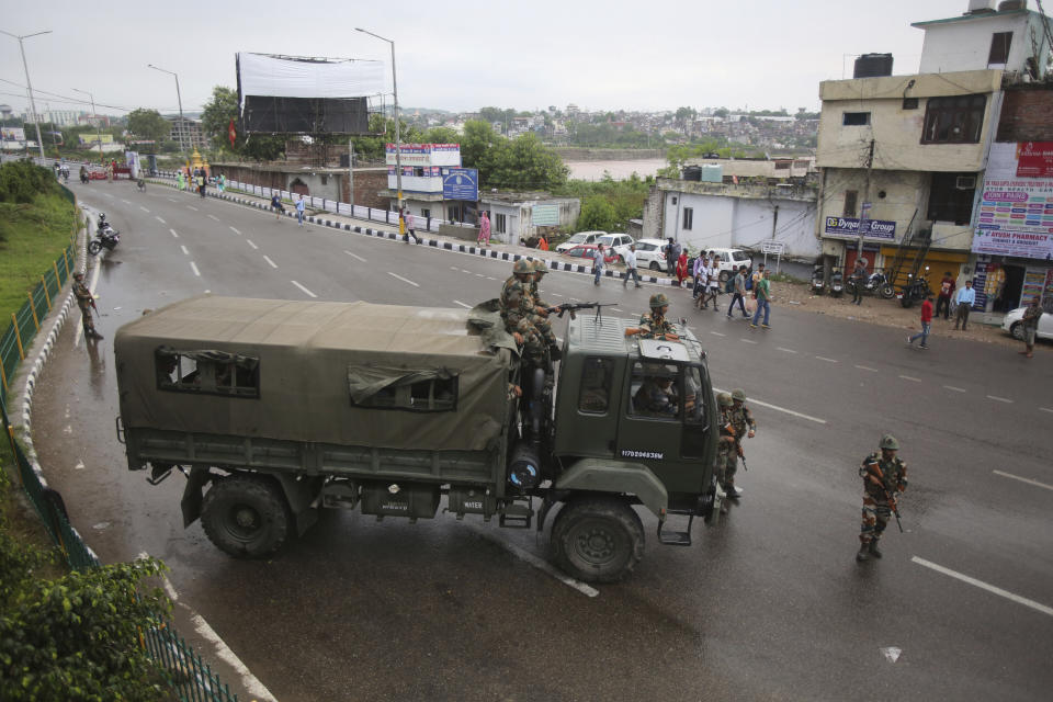 Indian army soldiers guard during curfew like restrictions in Jammu, India, Monday, Aug. 5, 2019. An indefinite security lockdown was in place in the Indian-controlled portion of divided Kashmir on Monday, stranding millions in their homes as authorities also suspended some internet services and deployed thousands of fresh troops around the increasingly tense region. (AP Photo/Channi Anand)