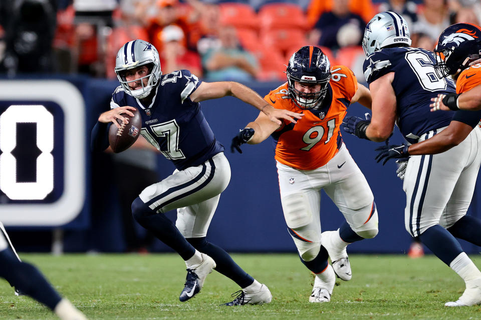 DENVER, CO – AUGUST 13: <a class="link " href="https://sports.yahoo.com/nfl/players/32901" data-i13n="sec:content-canvas;subsec:anchor_text;elm:context_link" data-ylk="slk:Ben DiNucci;sec:content-canvas;subsec:anchor_text;elm:context_link;itc:0">Ben DiNucci</a> #17 of the <a class="link " href="https://sports.yahoo.com/nfl/teams/dallas/" data-i13n="sec:content-canvas;subsec:anchor_text;elm:context_link" data-ylk="slk:Dallas Cowboys;sec:content-canvas;subsec:anchor_text;elm:context_link;itc:0">Dallas Cowboys</a> avoids a sack by Matt Henningsen #91 of the Denver Broncos during a preseason game at Empower Field At Mile High on August 13, 2022 in Denver, Colorado. (Photo by Jamie Schwaberow/Getty Images)