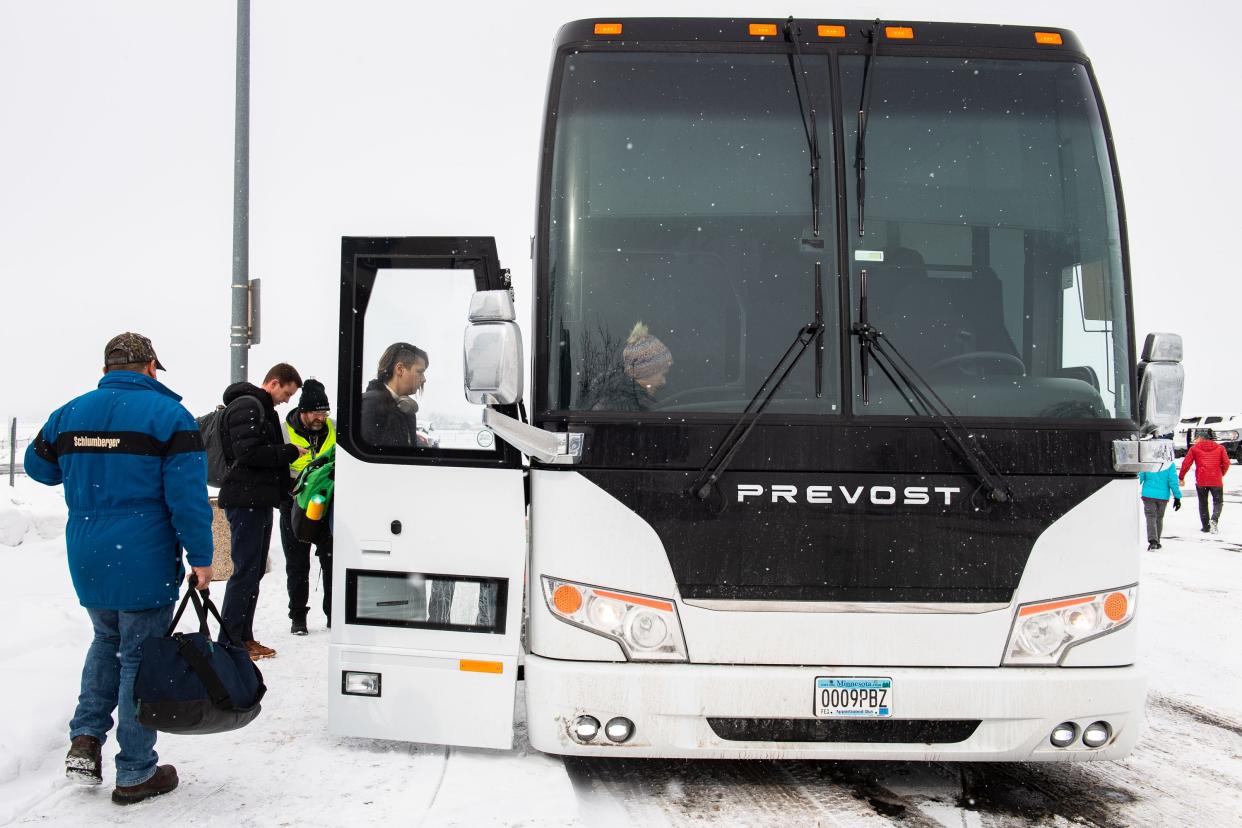 People board a Landline shuttle bus at the Northern Colorado Regional Airport on Jan. 30 in Loveland.