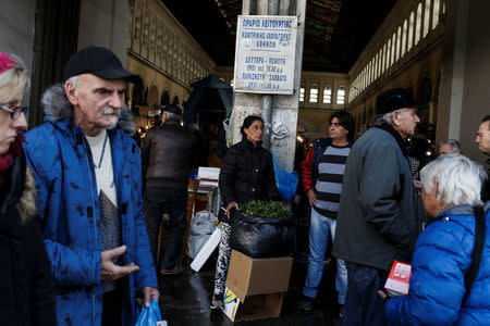 People make their way outside the main fish market of Athens, Greece, February 18, 2017. REUTERS/Alkis Konstantinidis