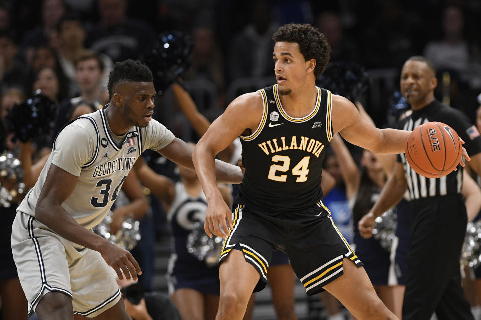 Villanova forward Jeremiah Robinson-Earl (24) dribbles the ball against Georgetown center Qudus Wahab (34) during the second half of an NCAA college basketball game, Saturday, March 7, 2020, in Washington. Villanova won 70-69. (AP Photo/Nick Wass)