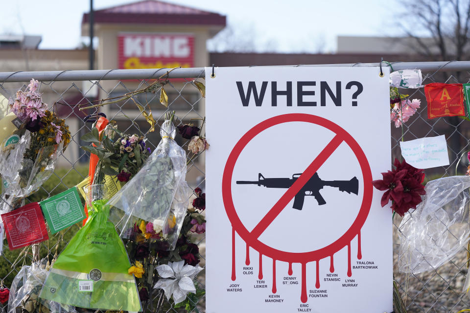 FILE - Tributes hang on the temporary fence surrounding the parking lot in front of a King Soopers grocery store in which 10 people died in a late March 2021 mass shooting, April 9, 2021, in Boulder, Colo. Attorneys will begin arguments Wednesday, Sept. 27, 2023, over whether the man accused of killing 10 people at a Colorado supermarket in 2021, Ahmad Al Aliwi Alissa, is mentally competent to proceed toward trial for the mass shooting. (AP Photo/David Zalubowski, File)