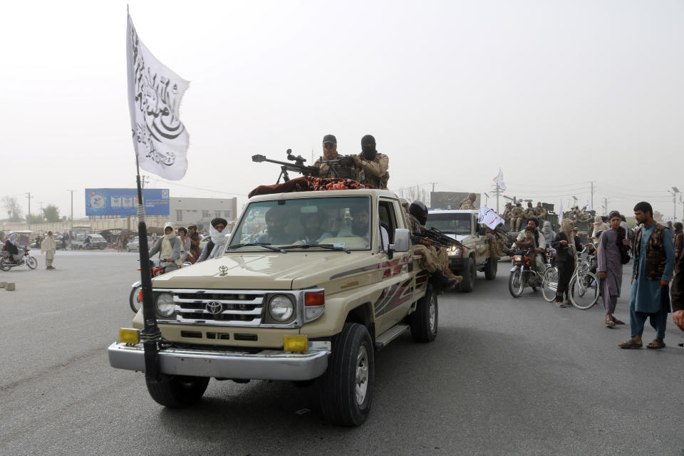 Taliban fighters patrol on the road during a celebration marking the second anniversary of the withdrawal of U.S.-led troops from Afghanistan, in Kandahar, south of Kabul, Afghanistan, Tuesday, Aug. 15, 2023. (AP Photo/Abdul Khaliq)