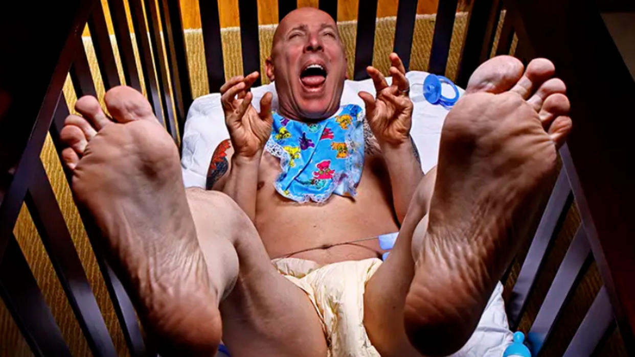  Maynard James Keenan dressed as a baby in a crib. 