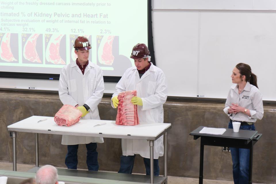 A member of the WT meat judging team explains how to grade a slab of beef Tuesday at a One West Campaign Steering Committee Meeting at West Texas A&M.