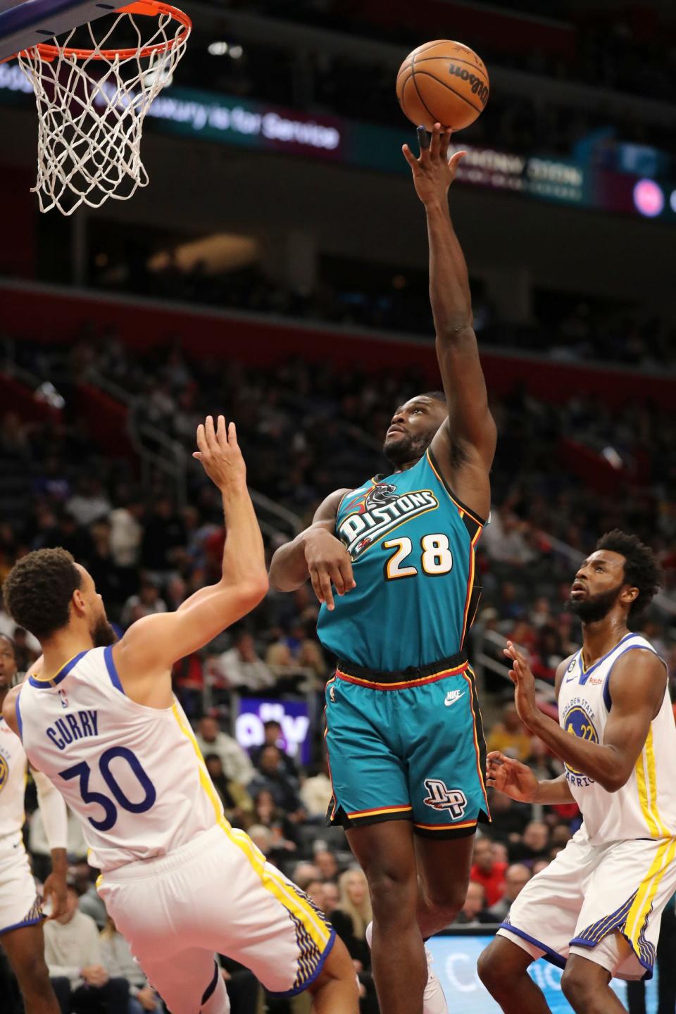 Detroit Pistons center Isaiah Stewart (28) scores against Golden State Warriors guard Stephen Curry (30) during second-quarter action at Little Caesars Arena in Detroit on Sunday, Oct. 30, 2022.