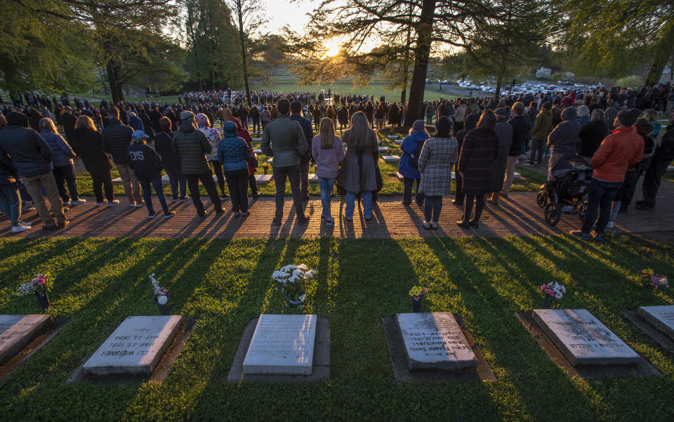 FILE - Worshippers listen to the liturgy as the sun rises over the Salem Congregation's God's Acre graveyard during the 251st Easter Sunrise Service of the Moravian Church, Sunday, April 9, 2023. On Easter morning, many Christians wake before dawn. They will celebrate their belief in the resurrection of Jesus, the son of God, as the sun rises. (Walt Unks/The Winston-Salem Journal via AP, File)