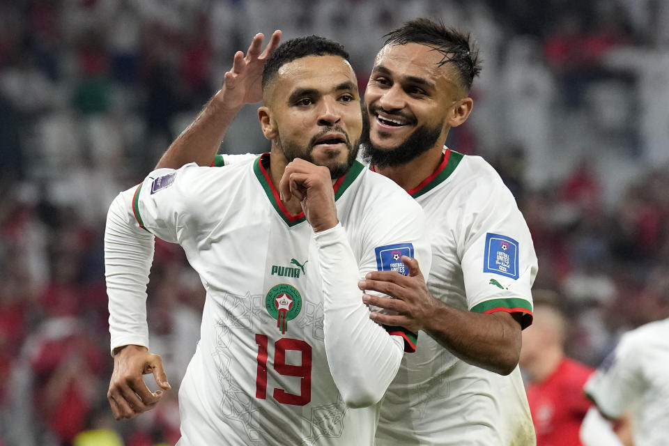 Morocco's Youssef En-Nesyri, left, celebrates beside Morocco's Sofiane Boufal, right, after he scored his side's second goal during the World Cup group F soccer match between Canada and Morocco at the Al Thumama Stadium in Doha , Qatar, Thursday, Dec. 1, 2022. (AP Photo/Natacha Pisarenko)