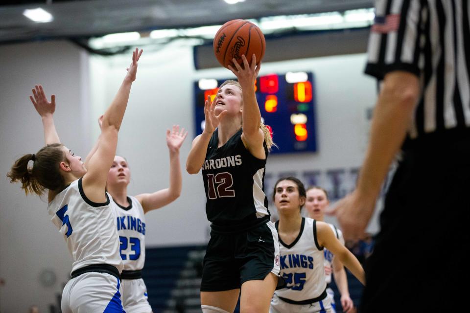 Holland Christian's Tryna VanderZwaag drives to the basket and takes a shot Wednesday, March 1, 2023, at Hopkins High School. 