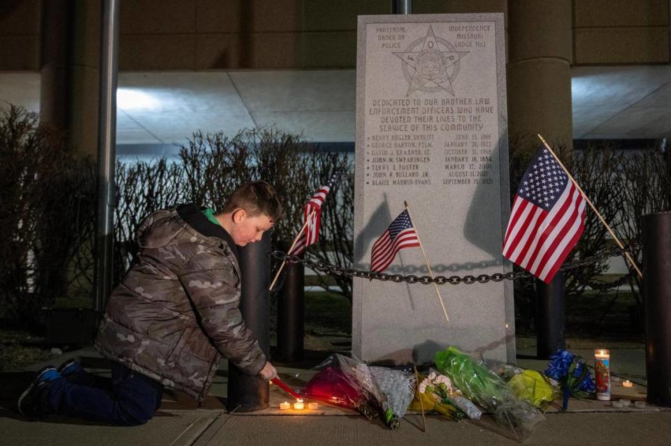Daniel Turner, 7, son of a Buckner police officer and the nephew of an Independence police officer, lit candles as he paid his respects to fallen Independence police officer Cody Allen, at the police memorial outside of the Independence Police Department, 223 N. Memorial Dr.. on Thursday, Feb. 29, 2024, in Independence. Daniel visited the memorial with his mother, Heather Parsons, of Independence, who said she learned of the shooting when Daniel’s school, Elm Grove Elementary went on lockdown in the Fort Osage School District.