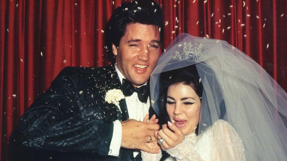 elvis presley and priscilla presley smiling at their wedding