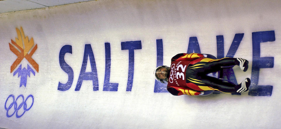 FILE - In this Feb. 9, 2002 ,file photo, Georg Hackl, of Germany, speeds past an Olympic logo during a practice run for the men's singles luge at the 2002 Salt Lake City Winter Olympics in Park City, Utah. Salt Lake City may shift its focus to bidding for the 2034 Winter Olympics rather than the games four years earlier following the announcement last month that Sapporo, Japan will bid for 2030, organizing committee members said Wednesday, Feb. 12, 2020. (AP Photo/Elise Amendola, File)