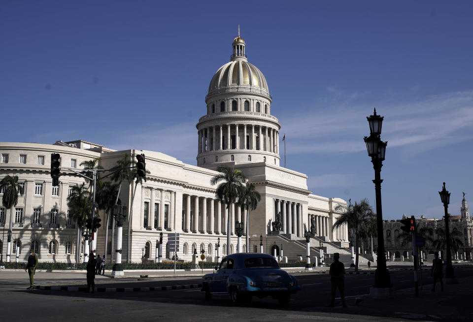 Police stand guard near the National Capitol building in Havana, Cuba, Monday, July 12, 2021, the day after protests against food shortages and high prices amid the coronavirus crisis. (AP Photo/Eliana Aponte)