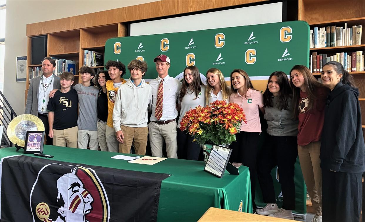 Pensacola Catholic senior Justin Lyons stands alongside his Crusader teammates after signing a letter of intent to play tennis for Florida State University on Thursday, Nov. 10, 2022 from the Pensacola Catholic High School media center.