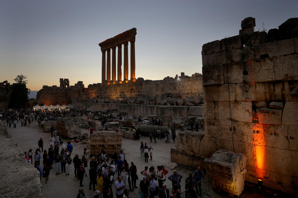 Visitors arrive for the concert of the French Pianist Simon Ghraichy in the ancient northeastern city of Baalbek, Lebanon, Sunday, July 17, 2022. Lebanon's renowned Baalbek Festival is back, held in front of a live audience for the first time in two years amid an ongoing economic meltdown. (AP Photo/Hassan Ammar)