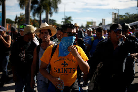People walk in a caravan of migrants departing from El Salvador en route to the United States, in San Salvador, El Salvador, October 28, 2018. REUTERS/Jose Cabezas