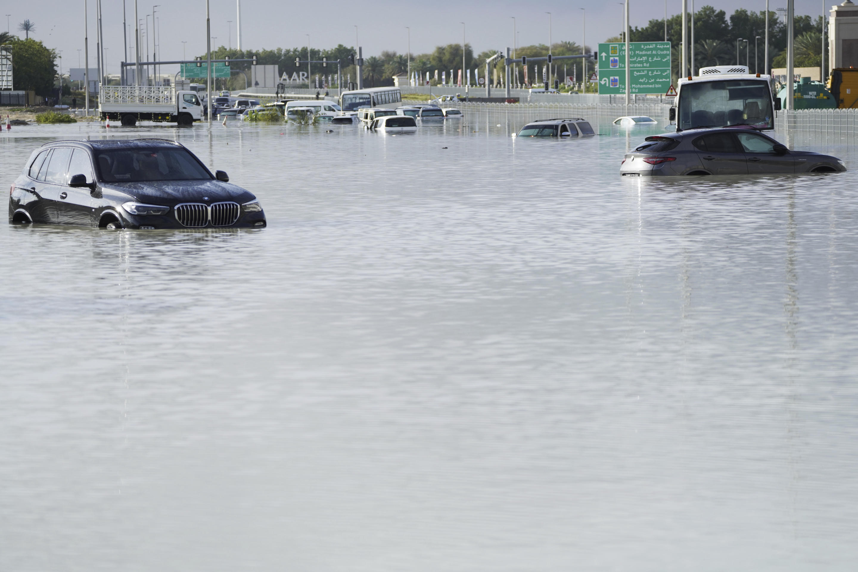 Abandoned vehicles are seen submerged in floodwaters on a major road in Dubai.