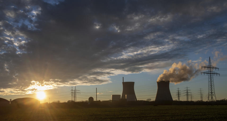 FILE - Steam rises from the cooling tower of the nuclear power plant of Gundremmingen, Bavaria, Germany, Friday, Dec. 31, 2021. Draft European Union plans that would allow nuclear and gas energy to remain part of the bloc's path to a climate-friendly future came under immediate criticism over the weekend from both environmentalists and some governing political parties in EU member nations. Germany shut three plants, including this one, at the end of last year. (Stefan Puchner/dpa via AP)