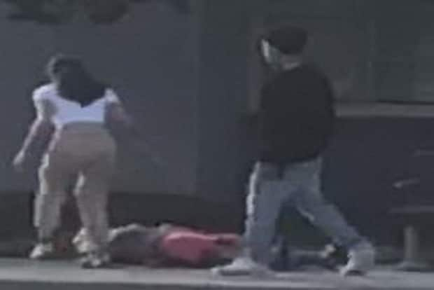 Richmond RCMP said images from video captured at the scene show someone coming to the young man's aid as the suspect walks away. (Richmond RCMP - image credit)