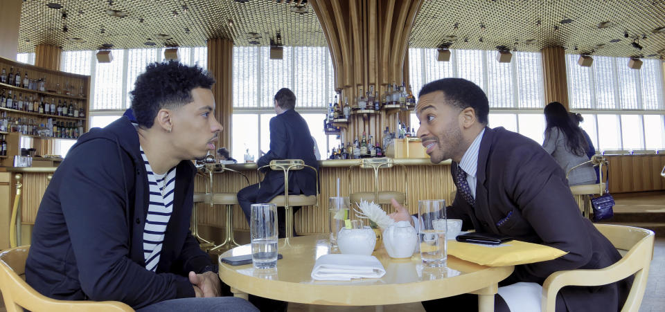 This image released by Netflix shows Melvin Gregg, left, and André Holland in a scene from "High Flying Bird." (Peter Andrews/Netflix via AP)