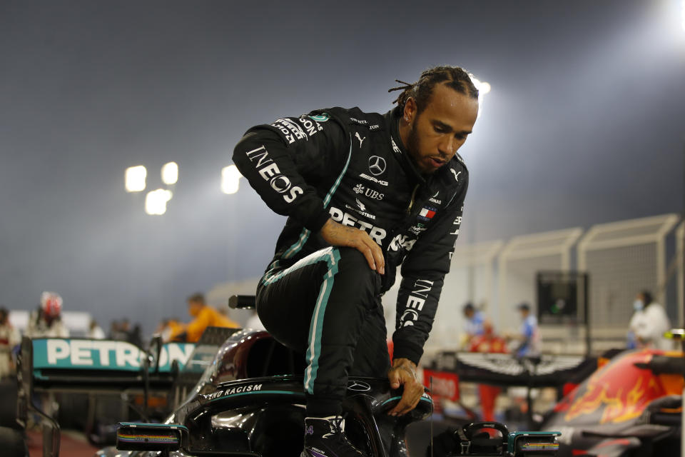 FILE - In this Sunday, Nov. 29, 2020 file photo Mercedes driver Lewis Hamilton of Britain exits his car after wining the Formula One race in Bahrain International Circuit in Sakhir, Bahrain. World champion Lewis Hamilton tested positive for COVID-19 and will miss the Sakhir Grand Prix this weekend, his Mercedes-AMG Petronas F1 Team said Tuesday Dec. 1, 2020. (Hamad Mohammed, Pool via AP, File)