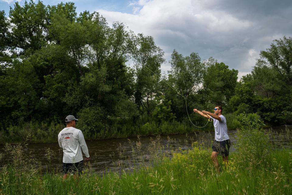 Keanu Gallegos, left, and Austin Hartman fly fish on the Poudre River at Lee Martinez Park in Fort Collins on June 21, 2023.