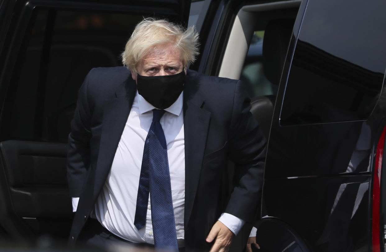 Britain's Prime Minister Boris Johnson arrives at the Northern Ireland Ambulance Service HQ during his visit to Belfast, Thursday, Aug. 13, 2020. (Brian Lawless/PA via AP)