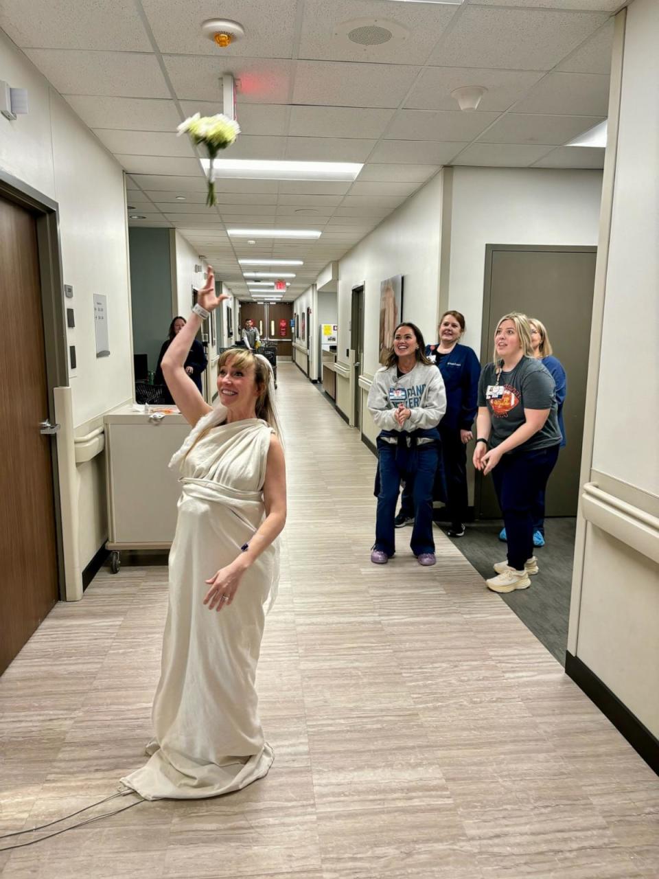 PHOTO: Sara Perry wore a wedding gown and veil fashioned from hospital linen and even had a bouquet toss with hospital nurses participating in the tradition. (Courtesy of Saint Luke’s East Hospital)