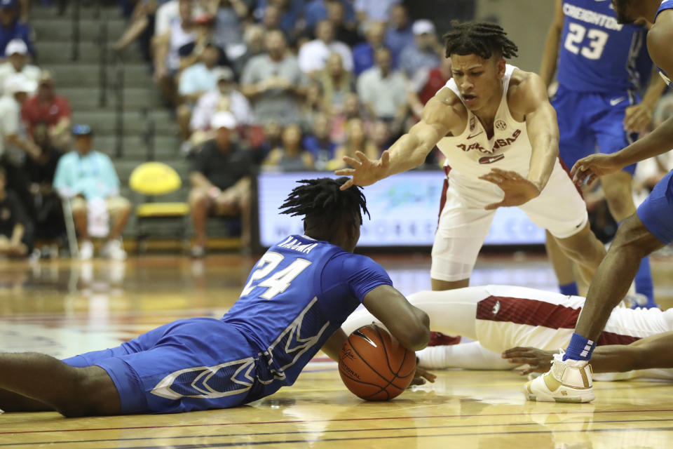 Creighton forward Arthur Kaluma (24) and Arkansas forward Trevon Brazile (2) fight for a loose ball during the first half of an NCAA college basketball game, Tuesday, Nov. 22, 2022, in Lahaina, Hawaii. (AP Photo/Marco Garcia)