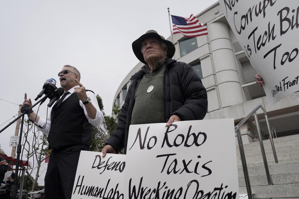 Edward Escobar, left, speaks in opposition to a proposed robotaxi expansion on Thursday, Aug. 10, 2023, in San Francisco. (AP Photo/Godofredo A. Vásquez)