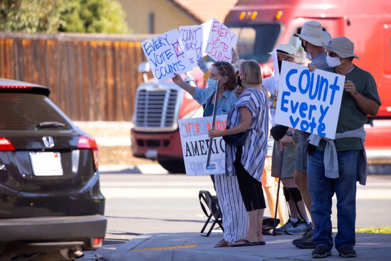 Demonstrators from protect the results coalition protests against efforts to not count all the votes in the general election as they demonstrate in Poway, California