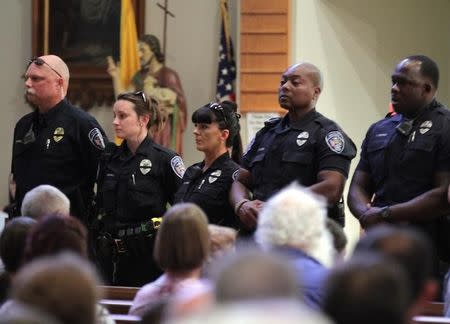 Police officers attend a church service after a fatal shooting of Baton Rouge policemen, at Saint John the Baptist Church in Zachary, Louisiana, July 17, 2016. REUTERS/Jeffrey Dubinsky